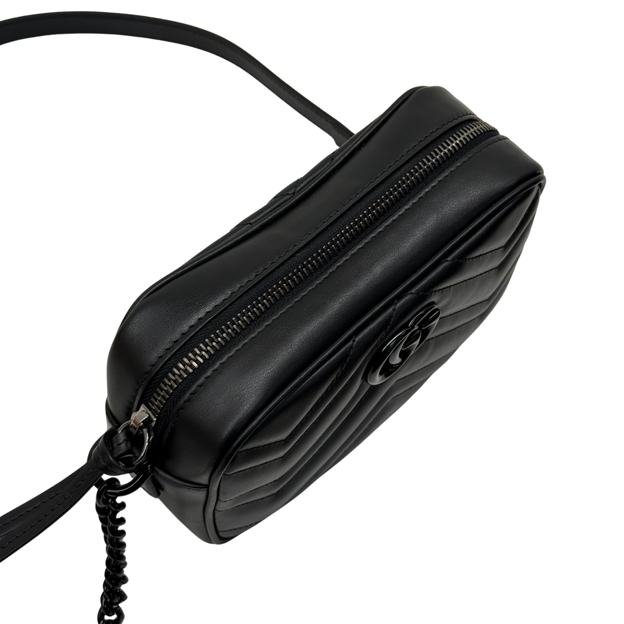 Black leather mini crossbody bag with GG logo, double zip top, front 3/4 view.
