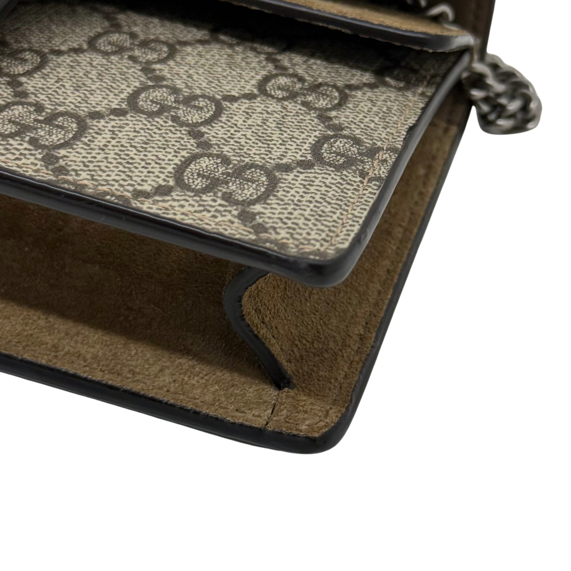 Gucci shoulder bag corner with black trim, GG canvas interior pocket edge