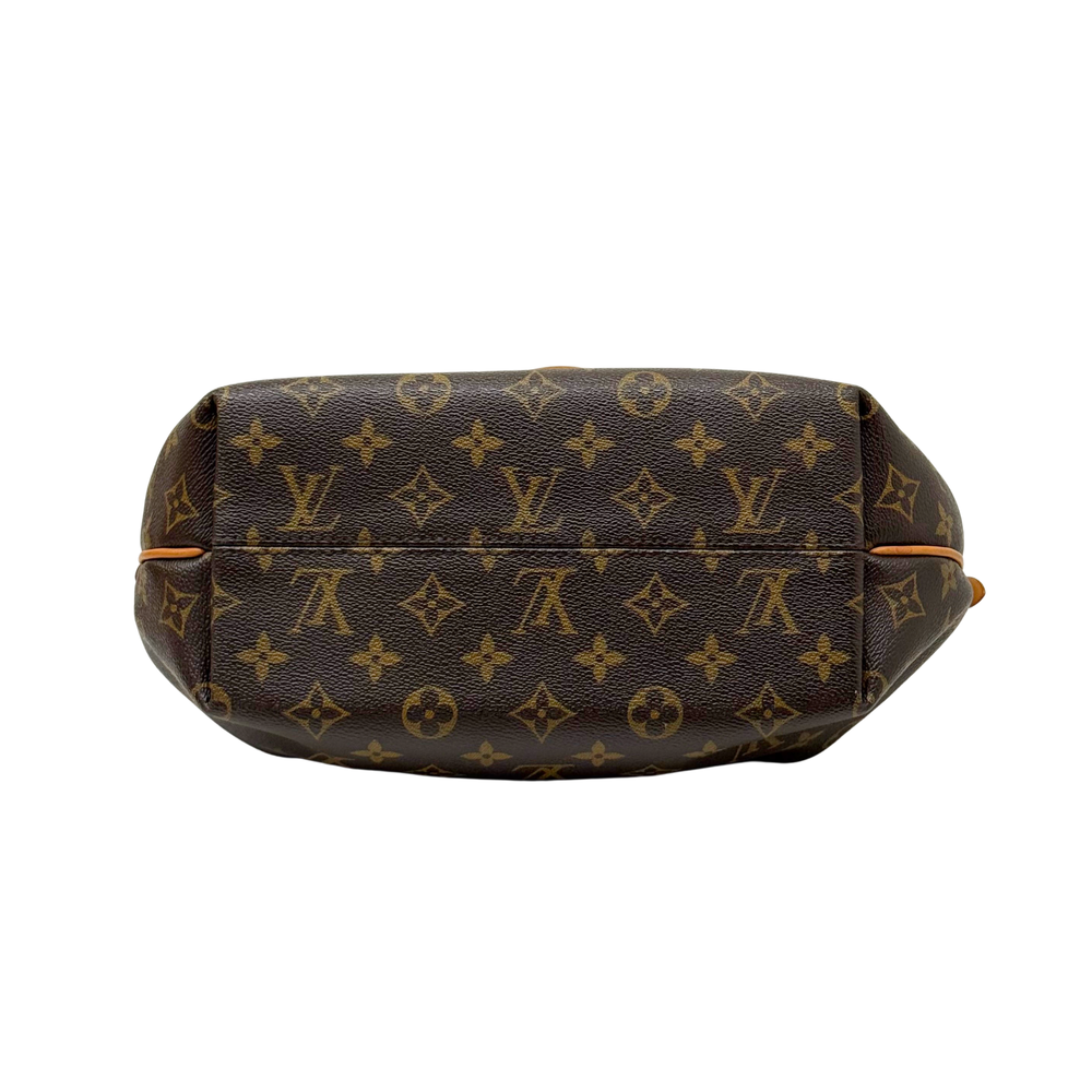 Louis Vuitton monogram handbag side view with leather trim and curved silhouette