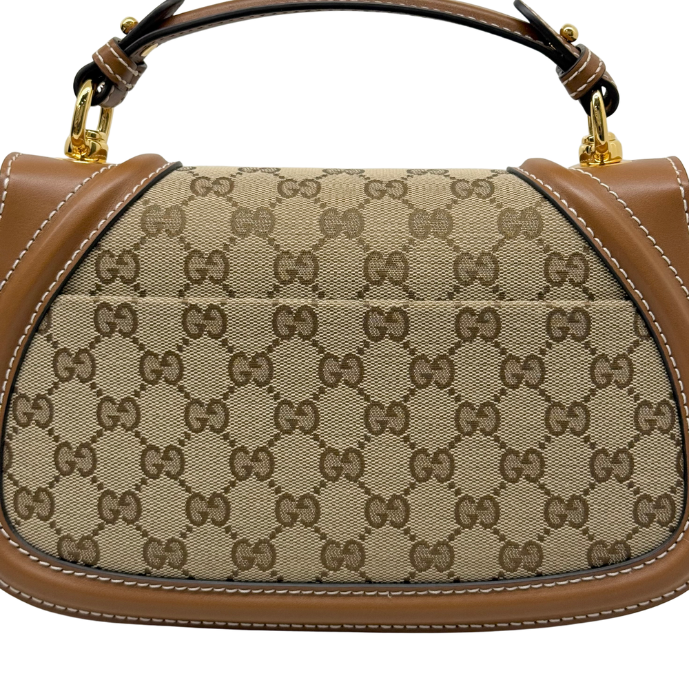 Monogram canvas interior panel with tan leather edge trim