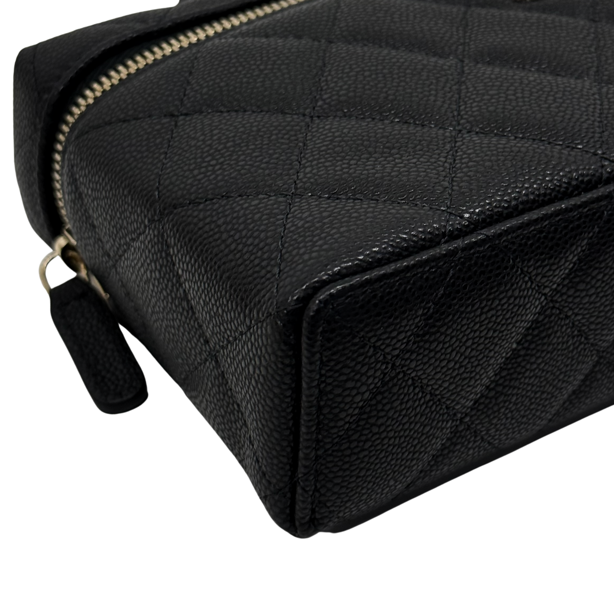 Black Chanel leather mini bag with quilted panels, gold zip, and loop handle