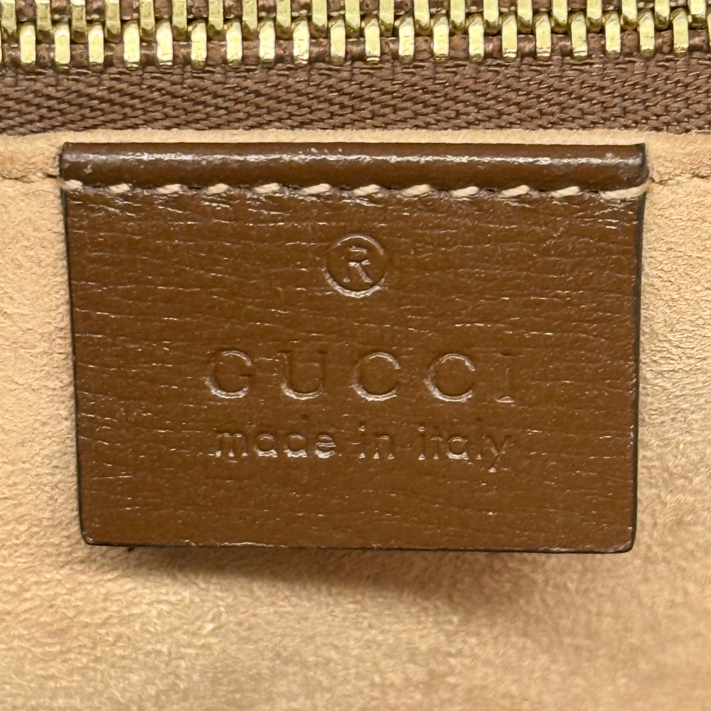 Pre-owned Gucci leather label with gold zipper teeth on brown bag