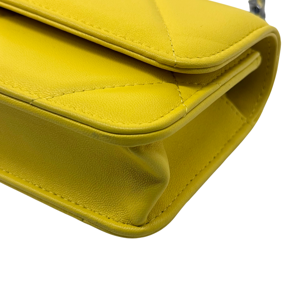 Yellow quilted leather flap with stitched edge and corner