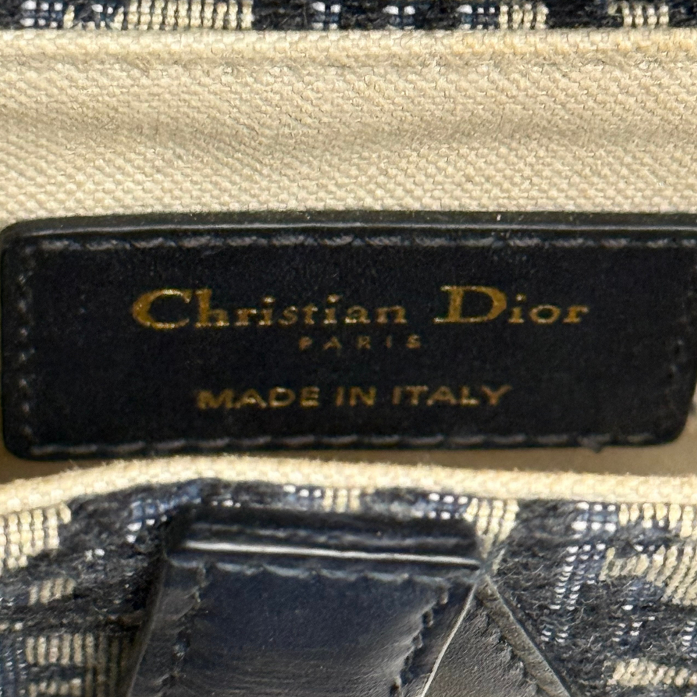 Pre-owned Dior saddle bag interior label, Made in Italy, on dark fabric