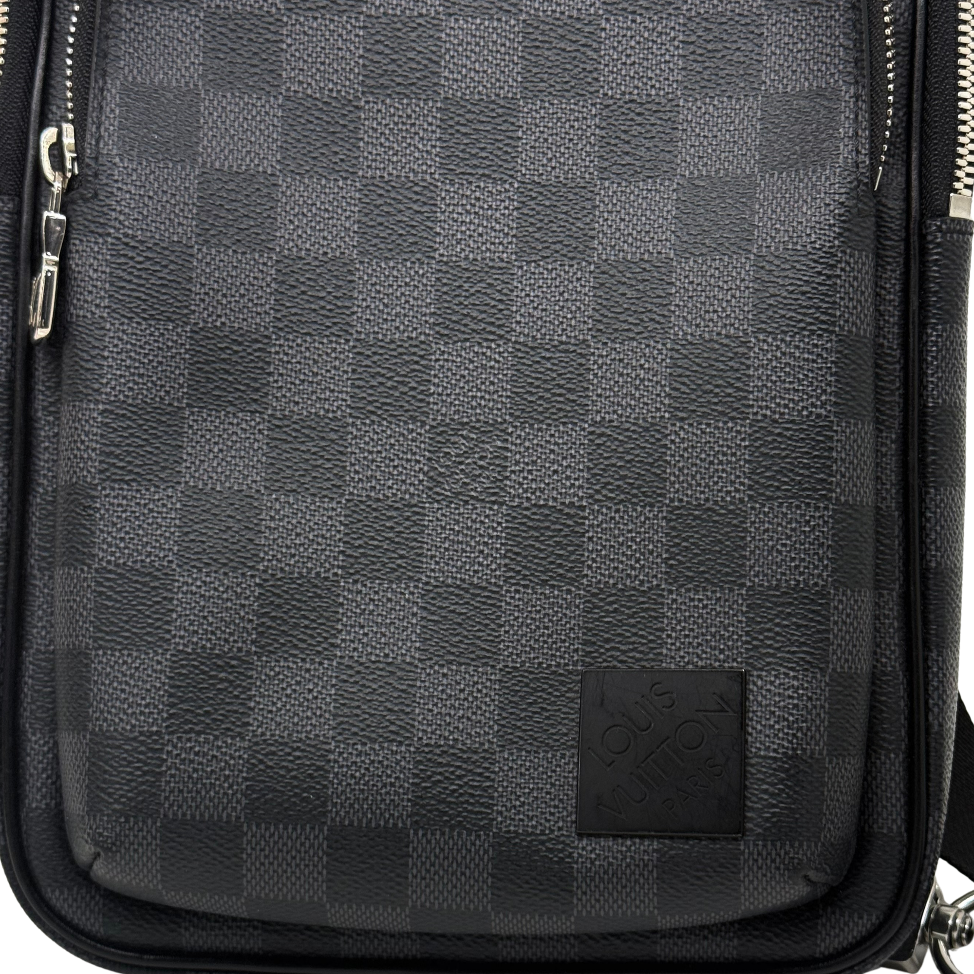 Dark checkered crossbody bag front panel with logo patch and leather trim