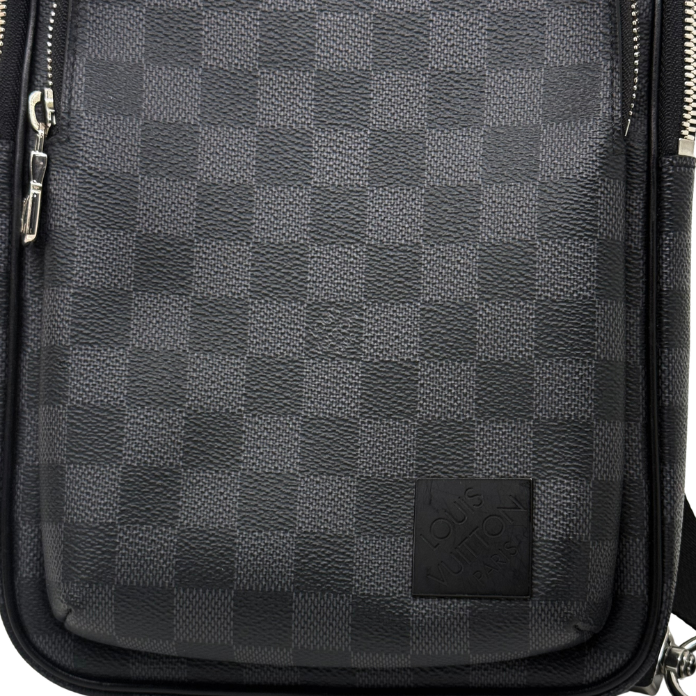 Dark checkered crossbody bag front panel with logo patch and leather trim