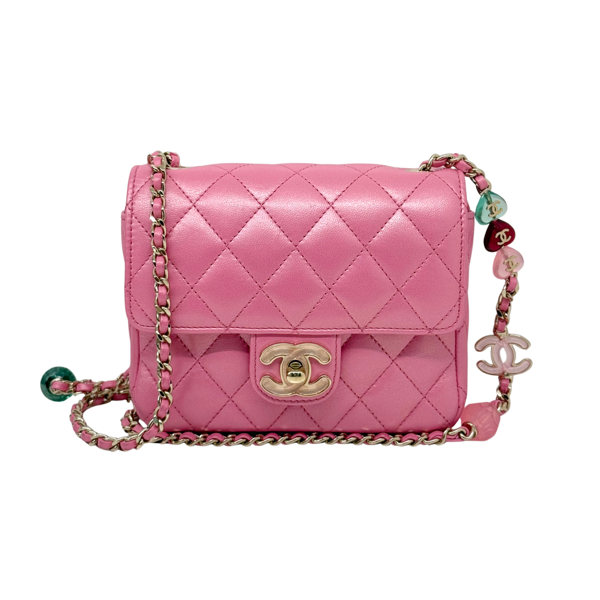 Chanel pink quilted crossbody bag with gold CC clasp and charm keychain detail