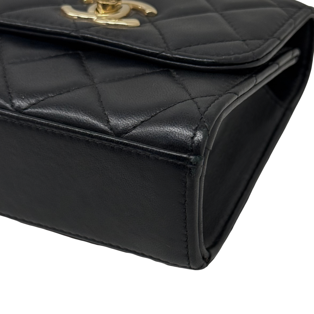 Black Chanel quilted mini flap bag corner with gold clasp and padded edge