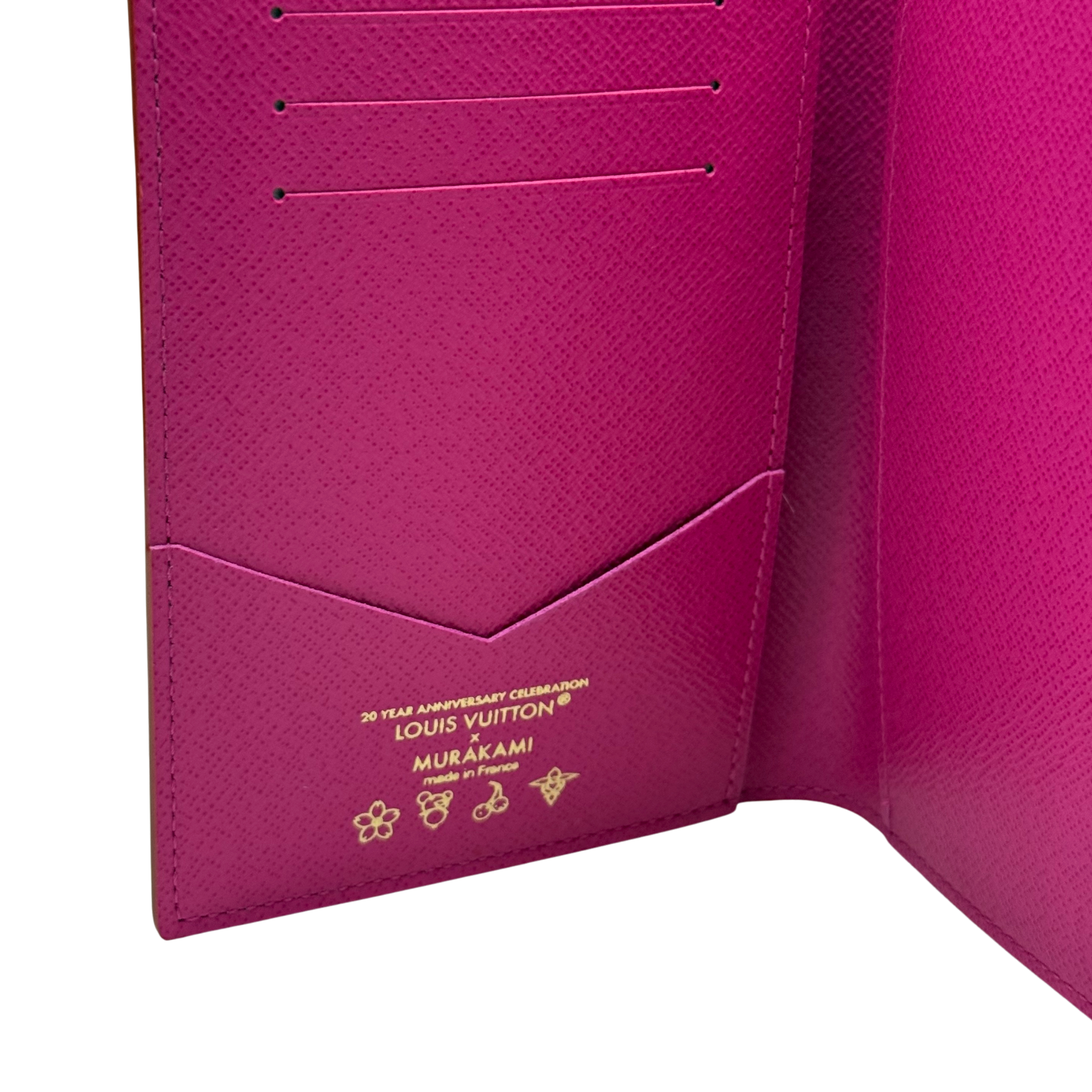 Fuchsia Louis Vuitton card holder with embossed monogram pattern and 5 card slots
