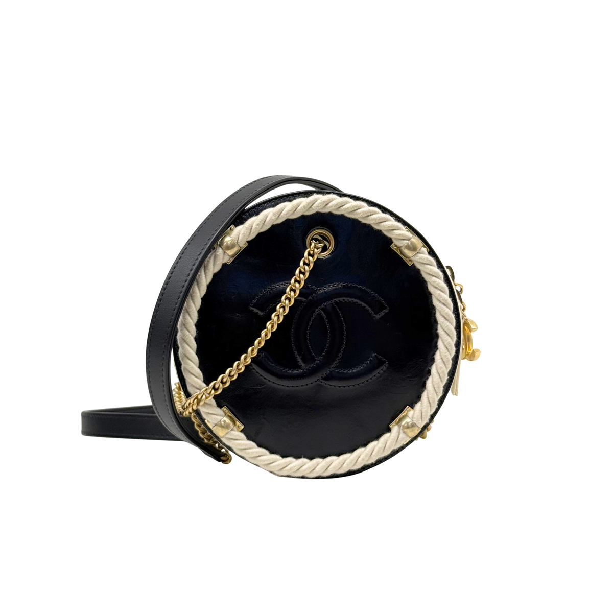Round Chanel mini bag with dark interior, gold chain strap, and braided trim.