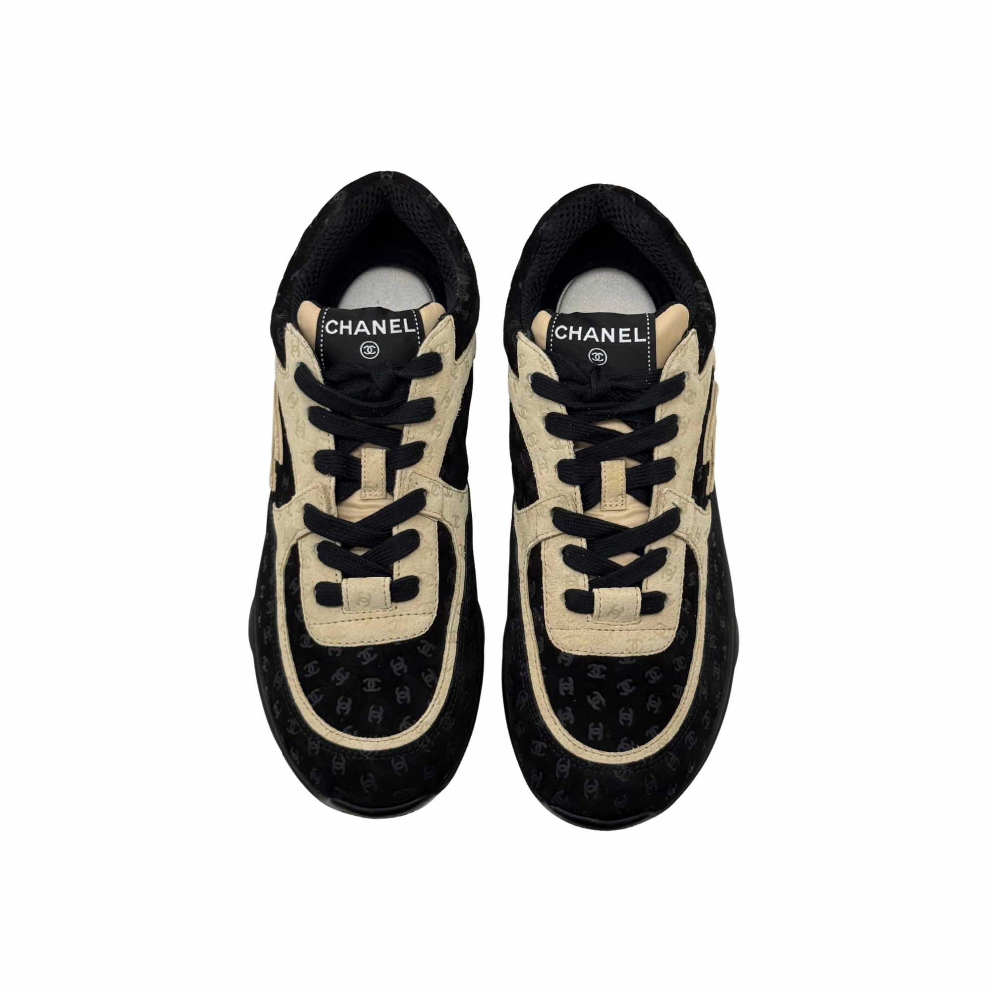 Black and beige Chanel sneakers front view with lace-up and logo detail on tongue