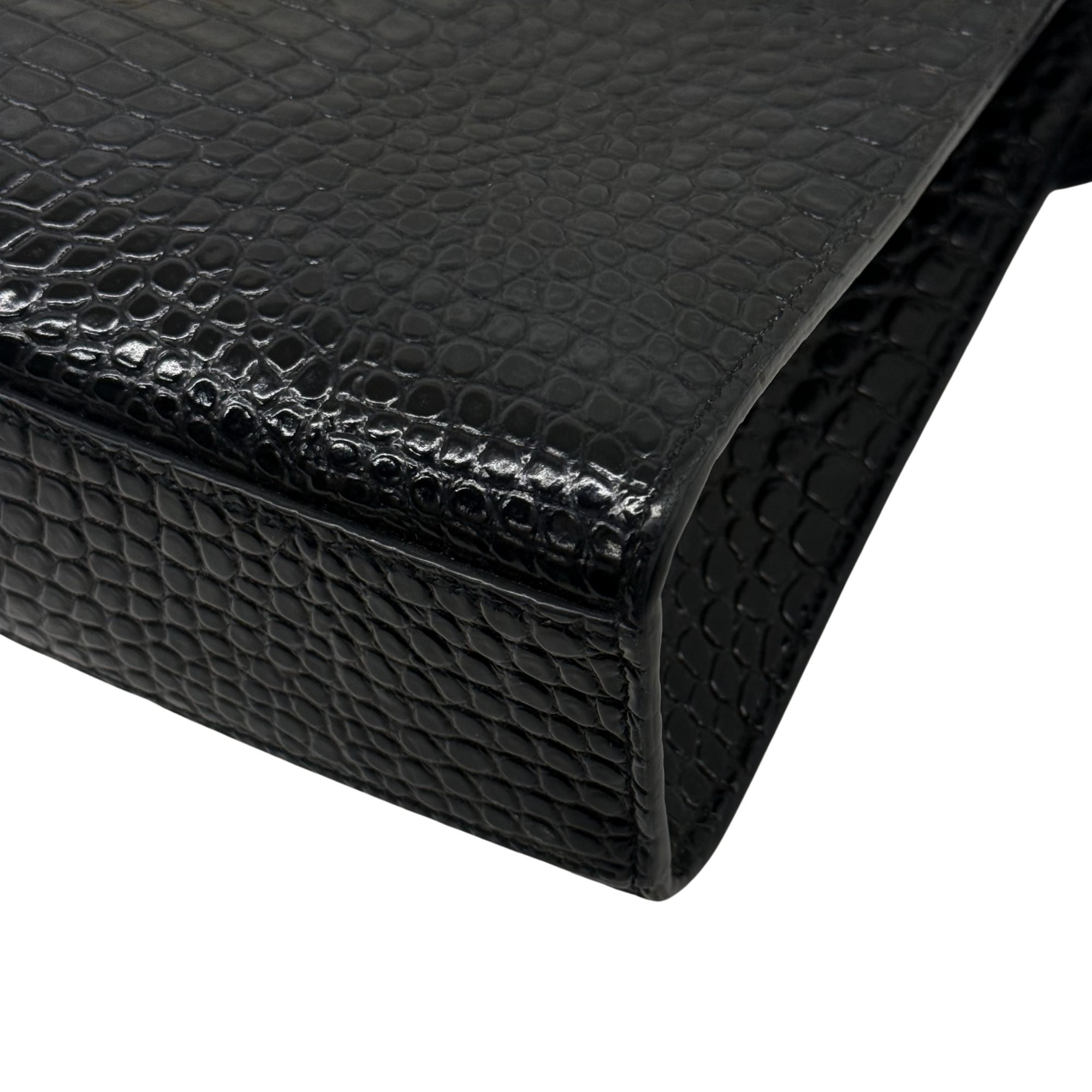 Black croc-embossed leather handbag corner and edge seam