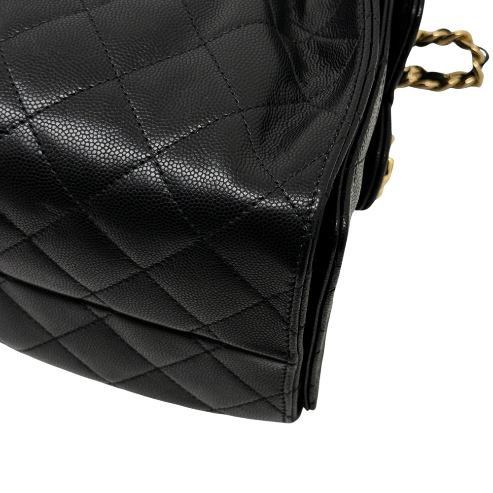 Black quilted leather handbag bottom corner with stitched pattern and edge seam