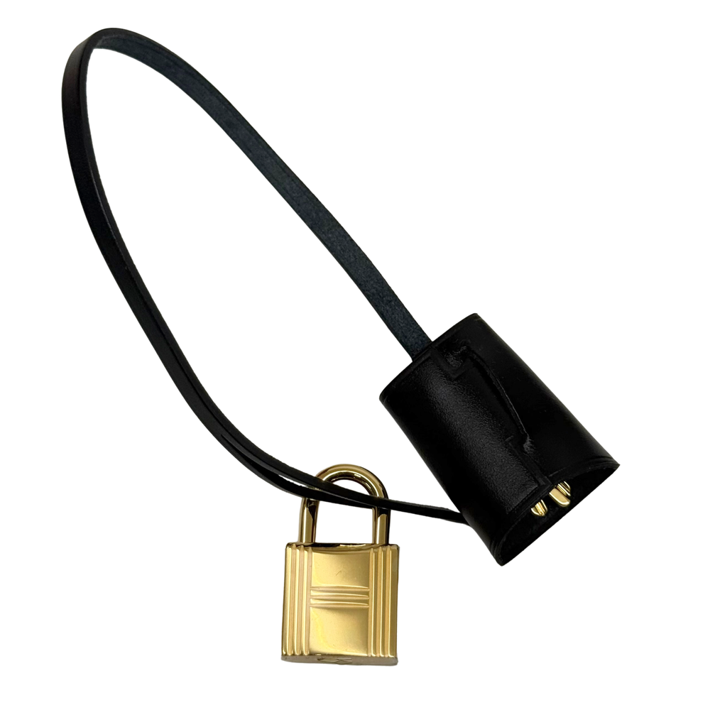 Hermes black leather strap with gold padlock charm and small black leather tab