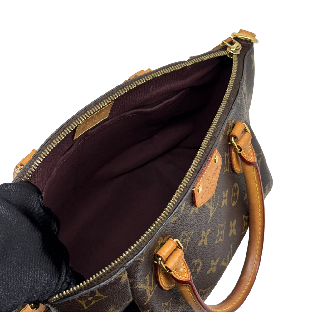 Louis Vuitton monogram handbag interior view with zip closure and leather tabs