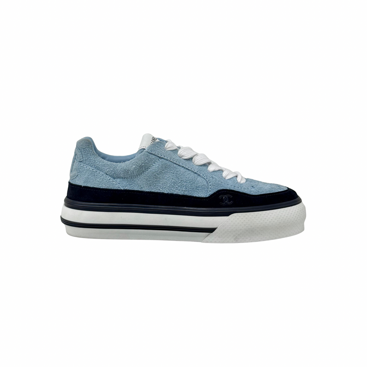 Light blue low-top sneaker with black trim and rubber sole, lace-up with Chanel logo