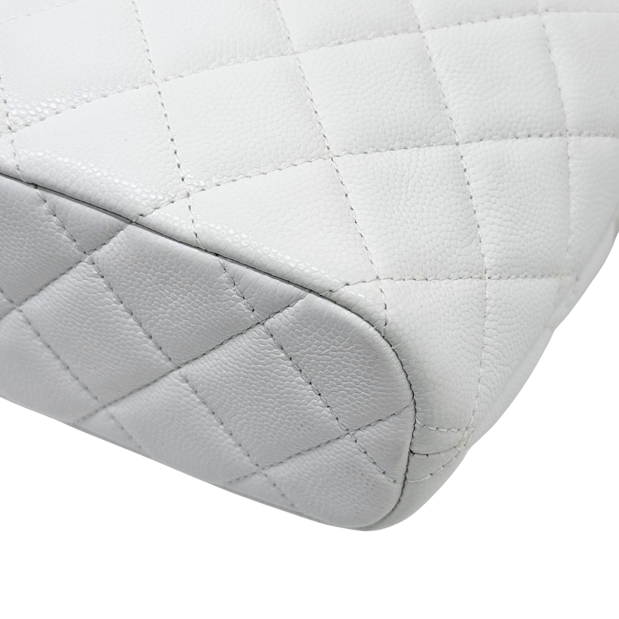 Chanel quilted white bag base corner with rounded seams and textured leather