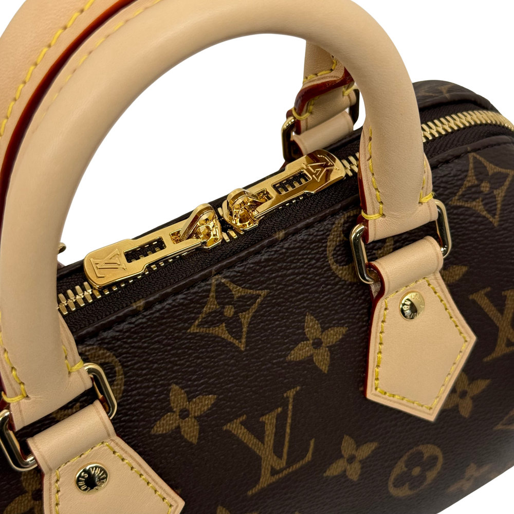 Louis Vuitton monogram handbag handle and gold zipper detail