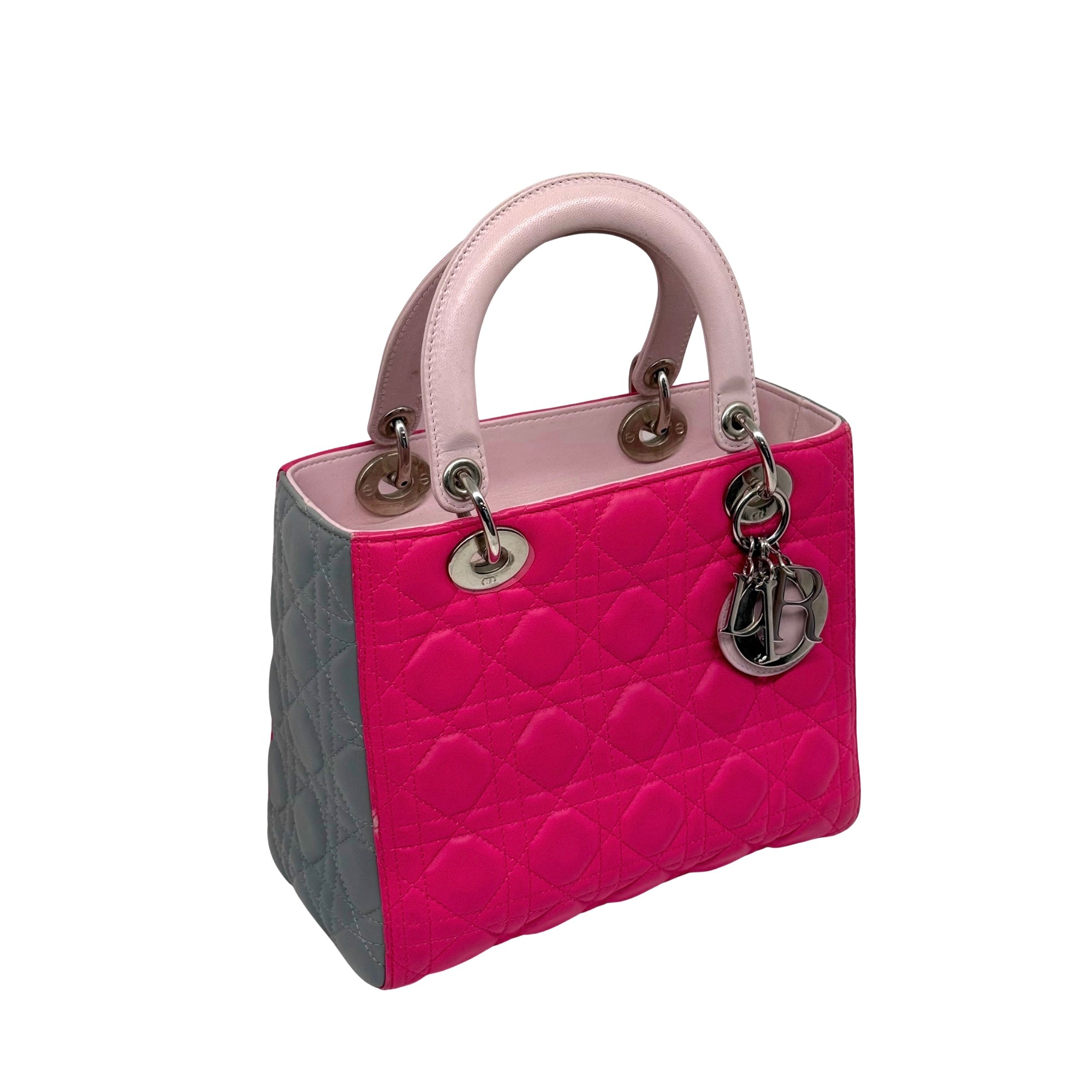 Two-tone fuchsia and gray quilted handbag with pink handles and charm detail