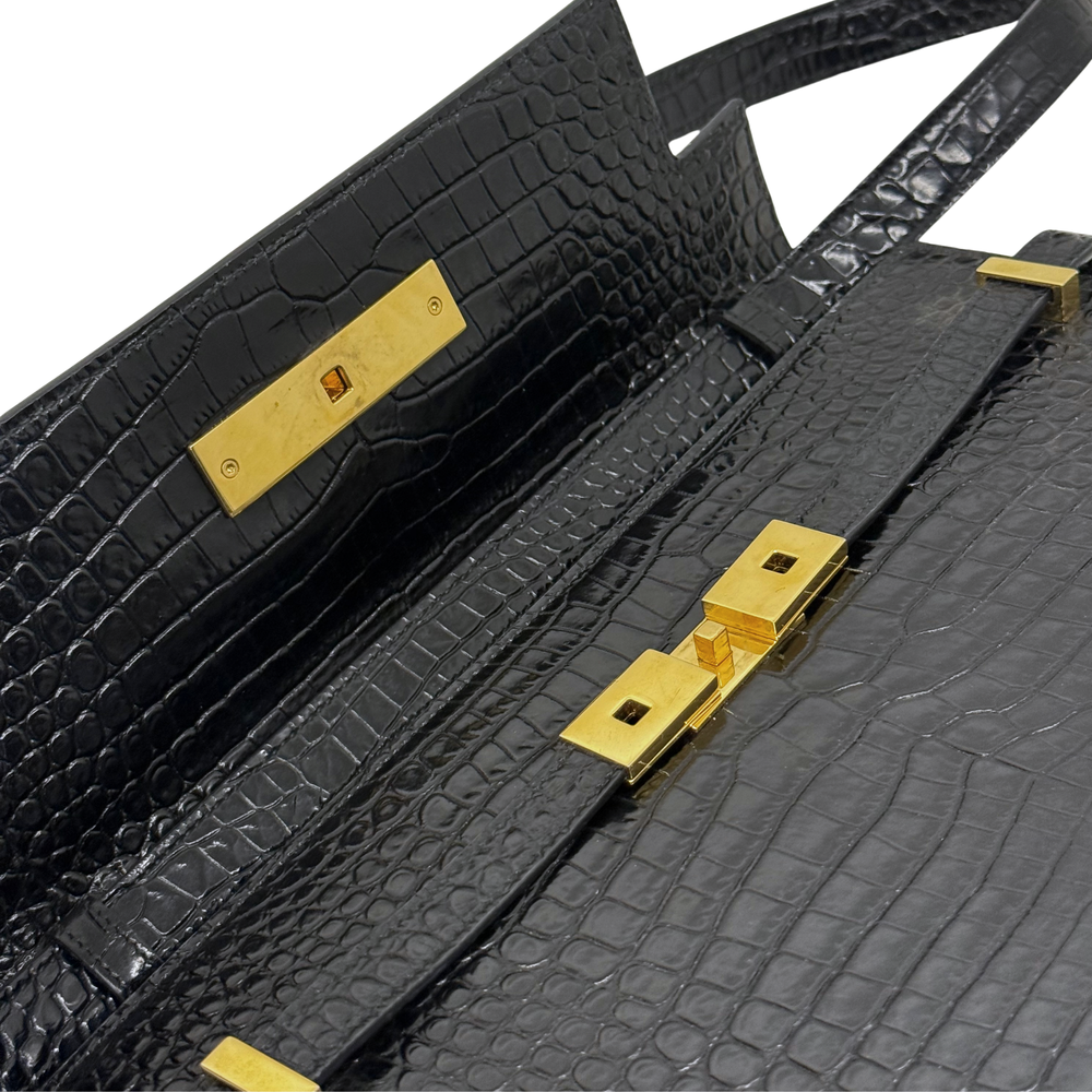 Black croc-embossed leather handbag interior panels with gold-tone hardware