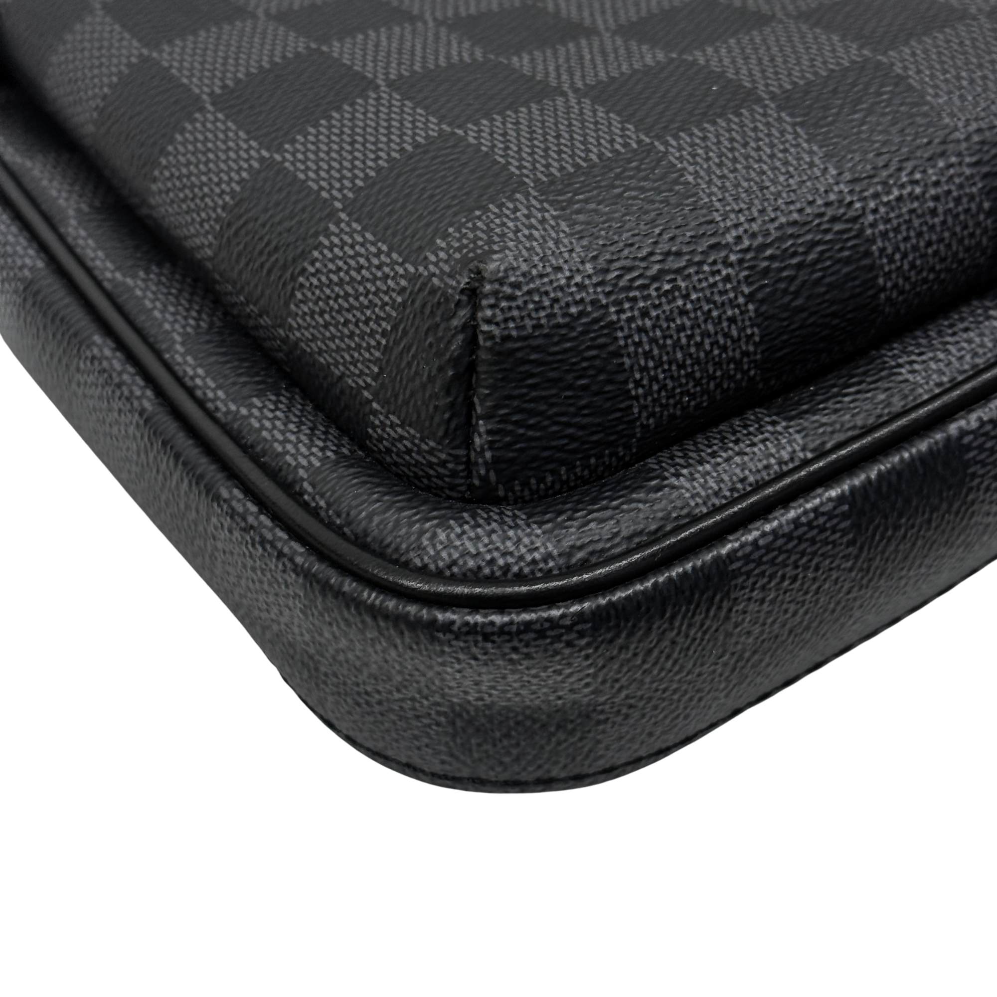 Black leather-trimmed bottom corner with stitched seam detail
