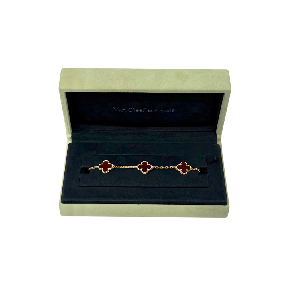 Van Cleef & Arpels bracelet in open box, red quatrefoil charms on gold chain