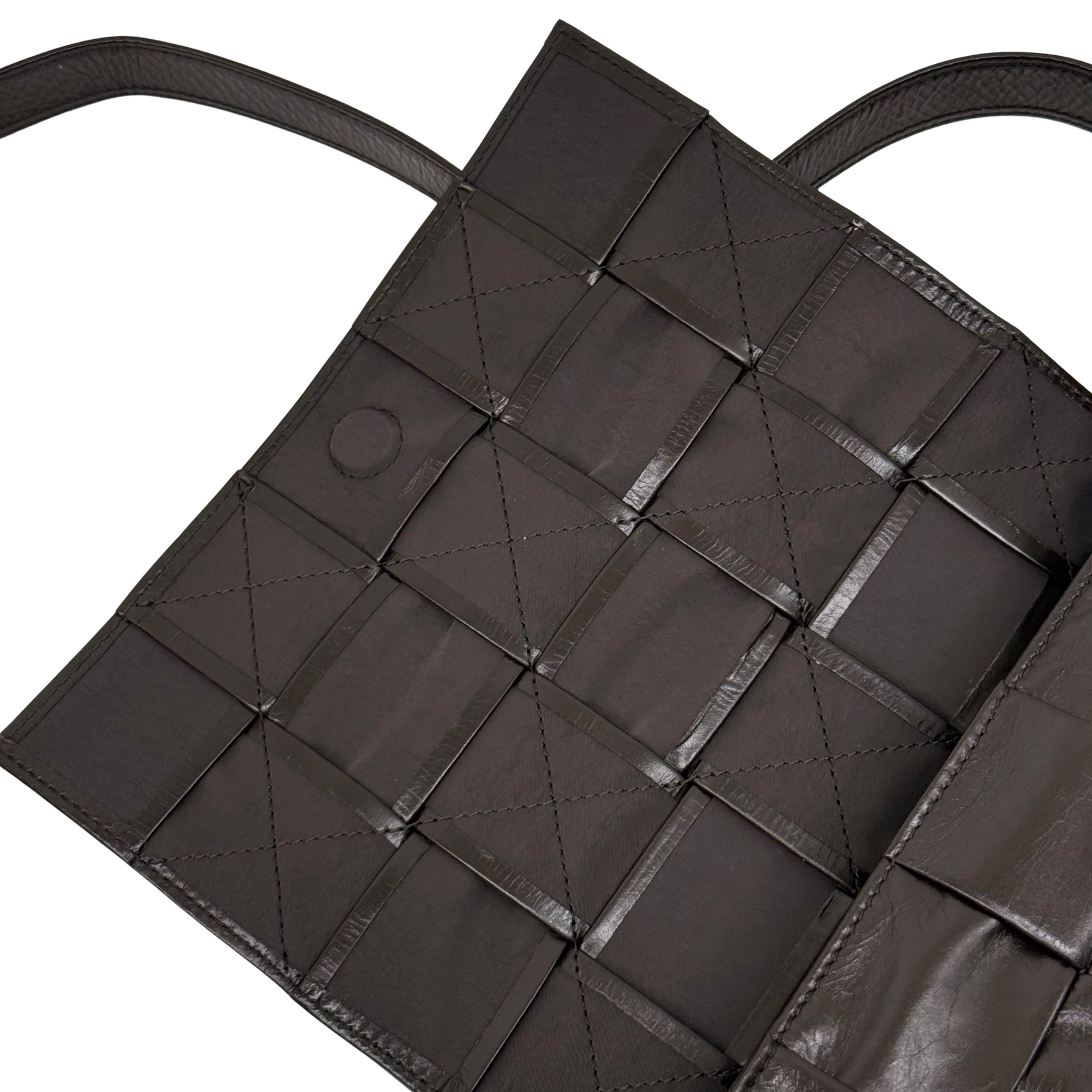 Quilted dark bag with open top, grid pockets, and inner snap tab