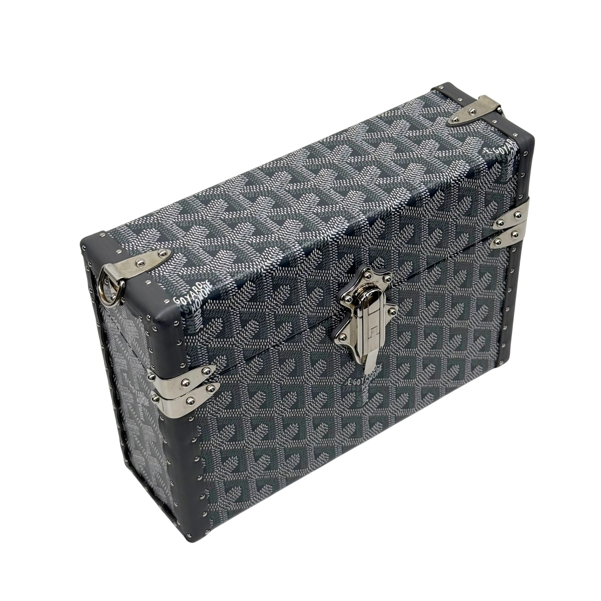 Goyard monogram trunk with silver corner fittings and dark top handle