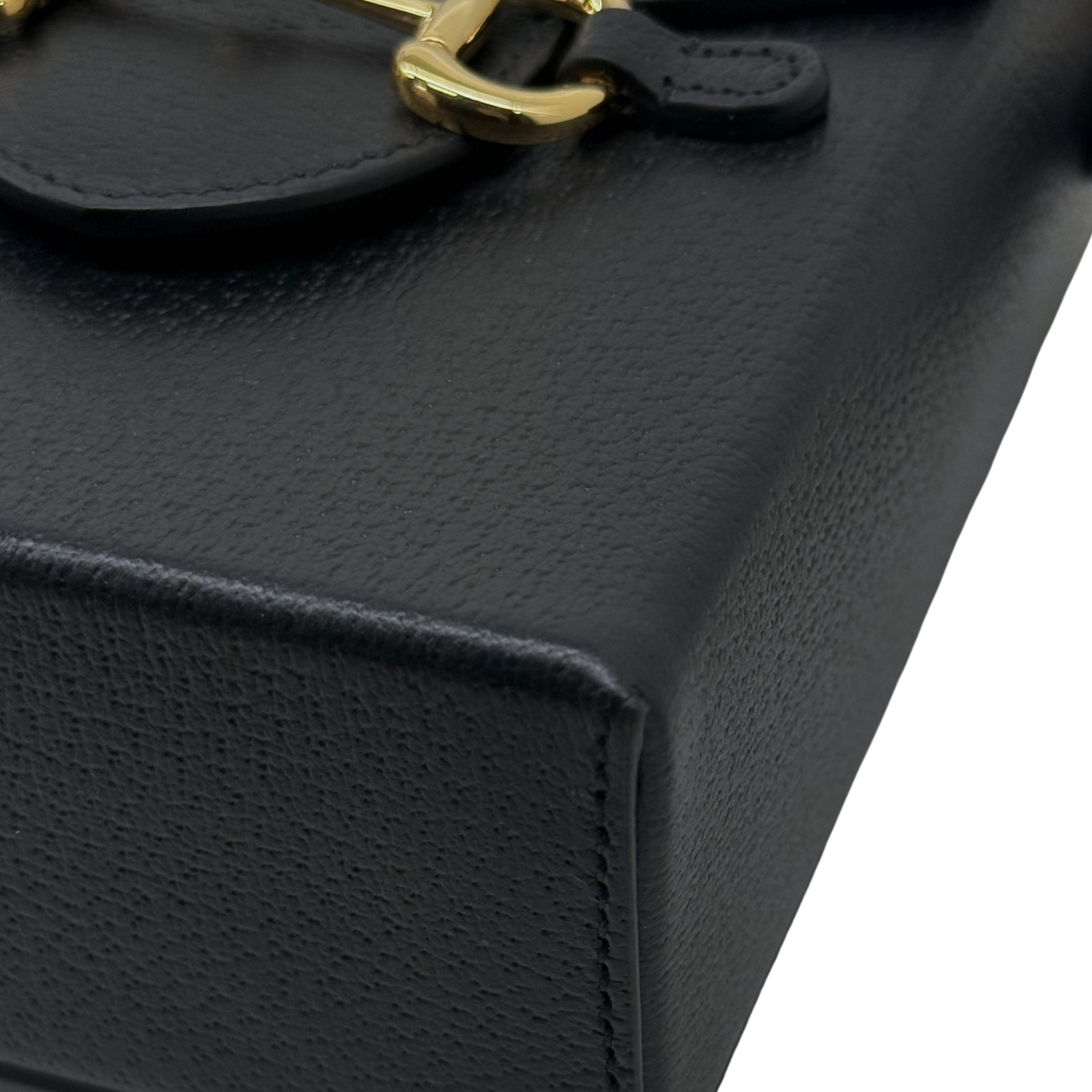 Gucci black leather bag side panel with stitched seams and gold hardware