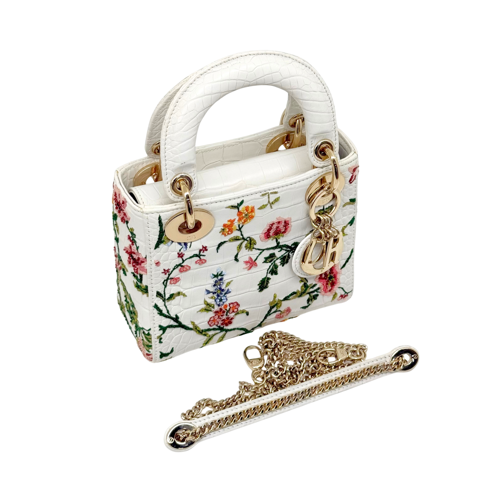White floral mini handbag with top handles and gold chain strap