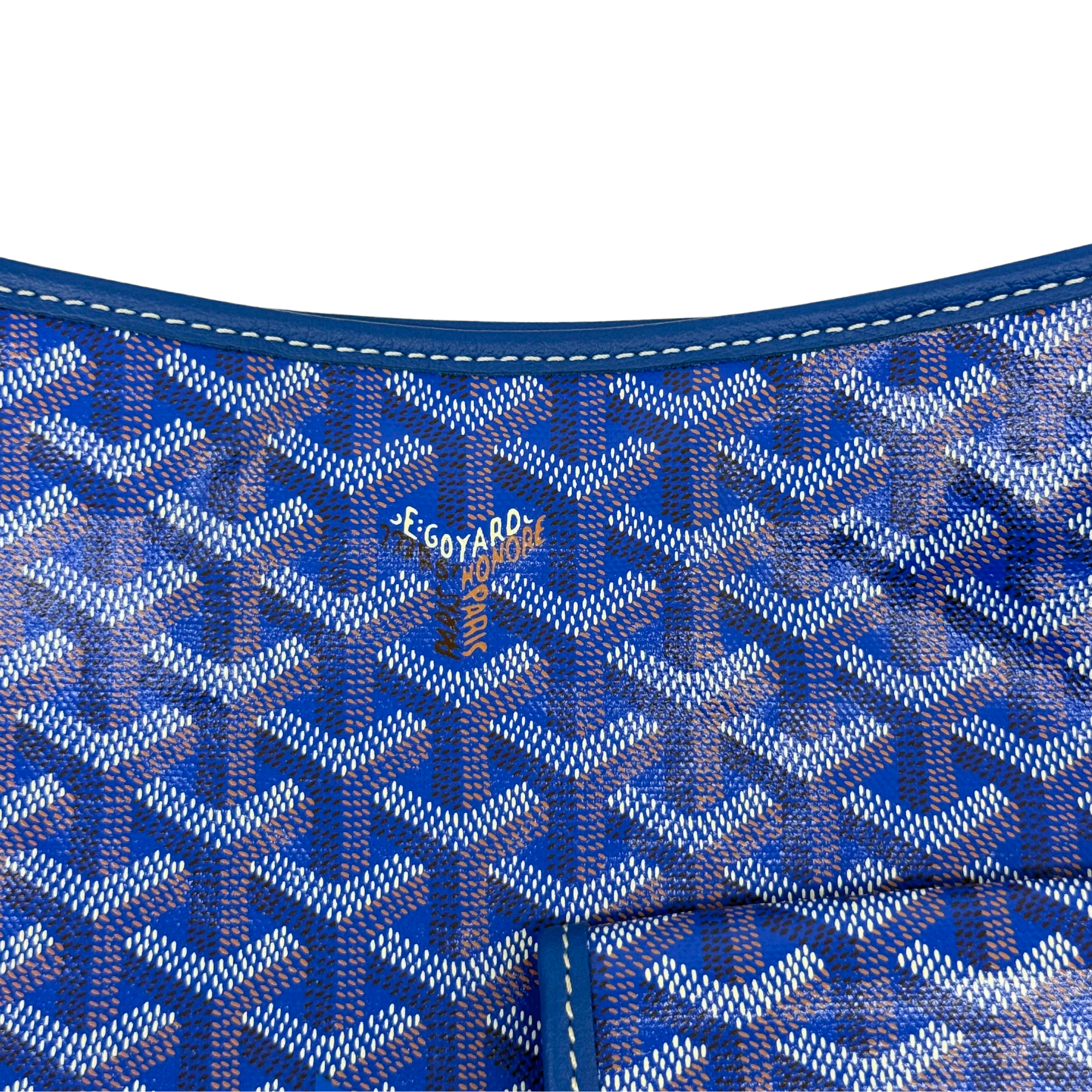 Blue patterned handbag interior with printed logo and stitched seams