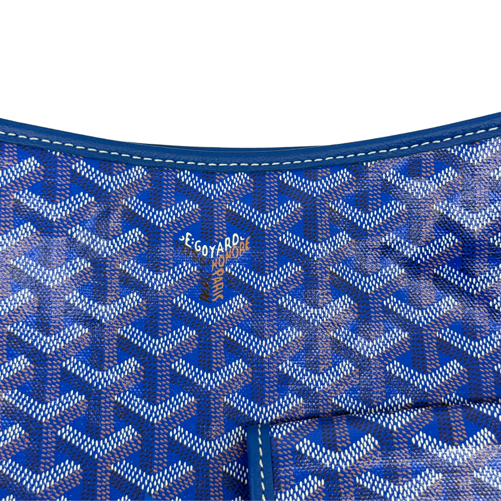 Blue patterned handbag interior with printed logo and stitched seams