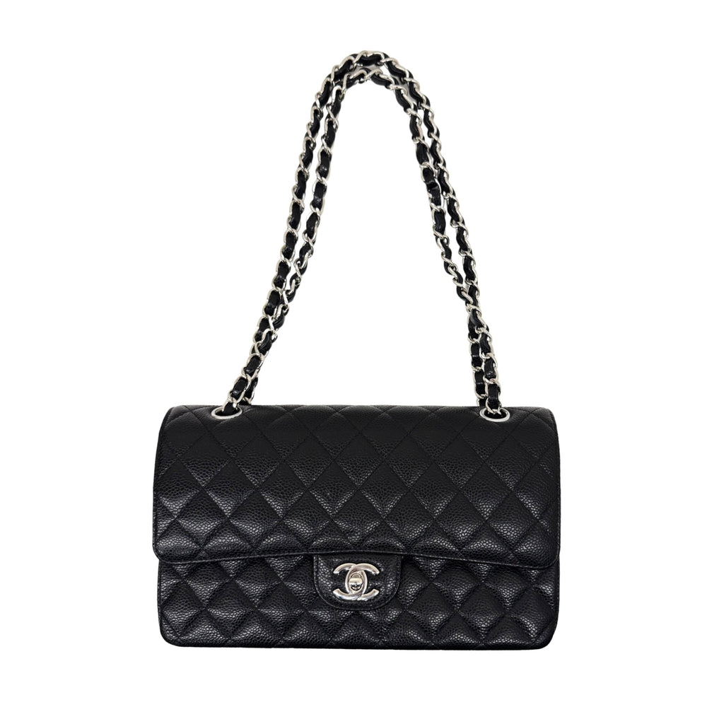 Black quilted shoulder bag with chain strap, flap closure, and Chanel CC logo