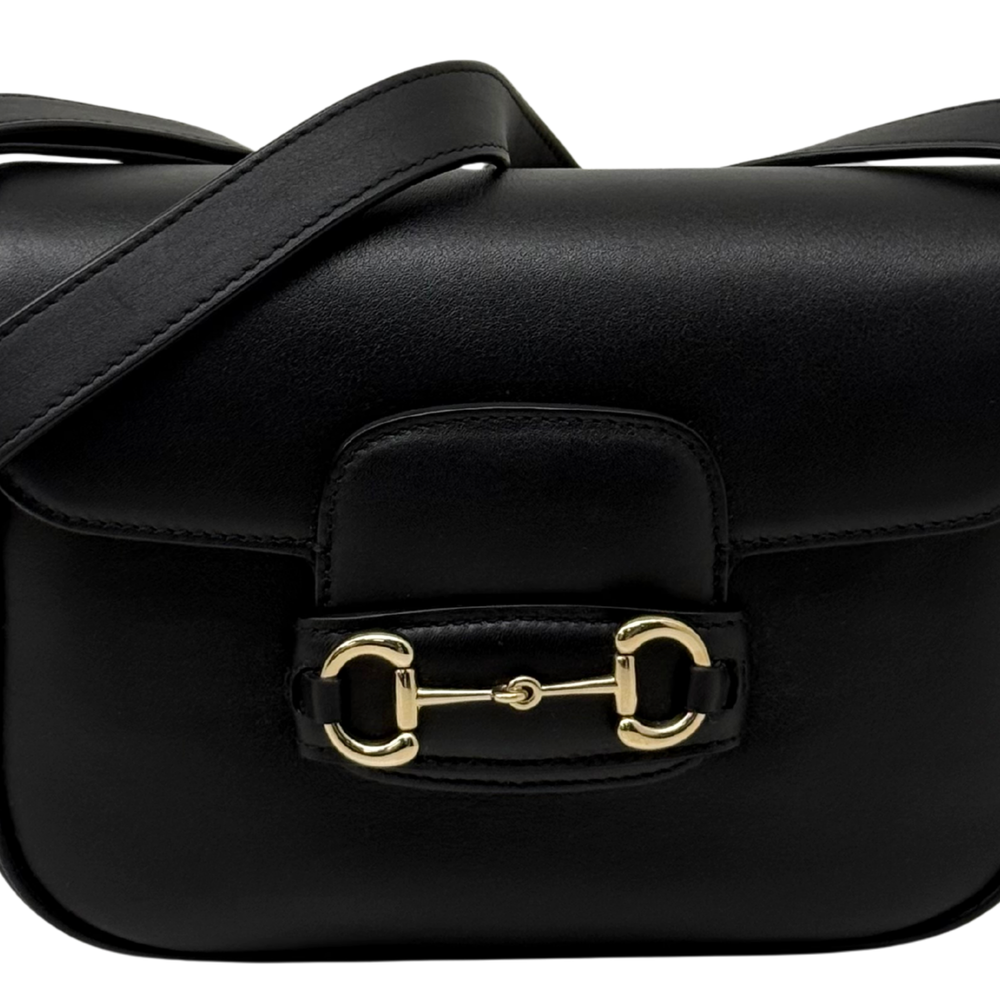 Gucci black leather flap bag front with padded panel and gold-tone clasp hardware