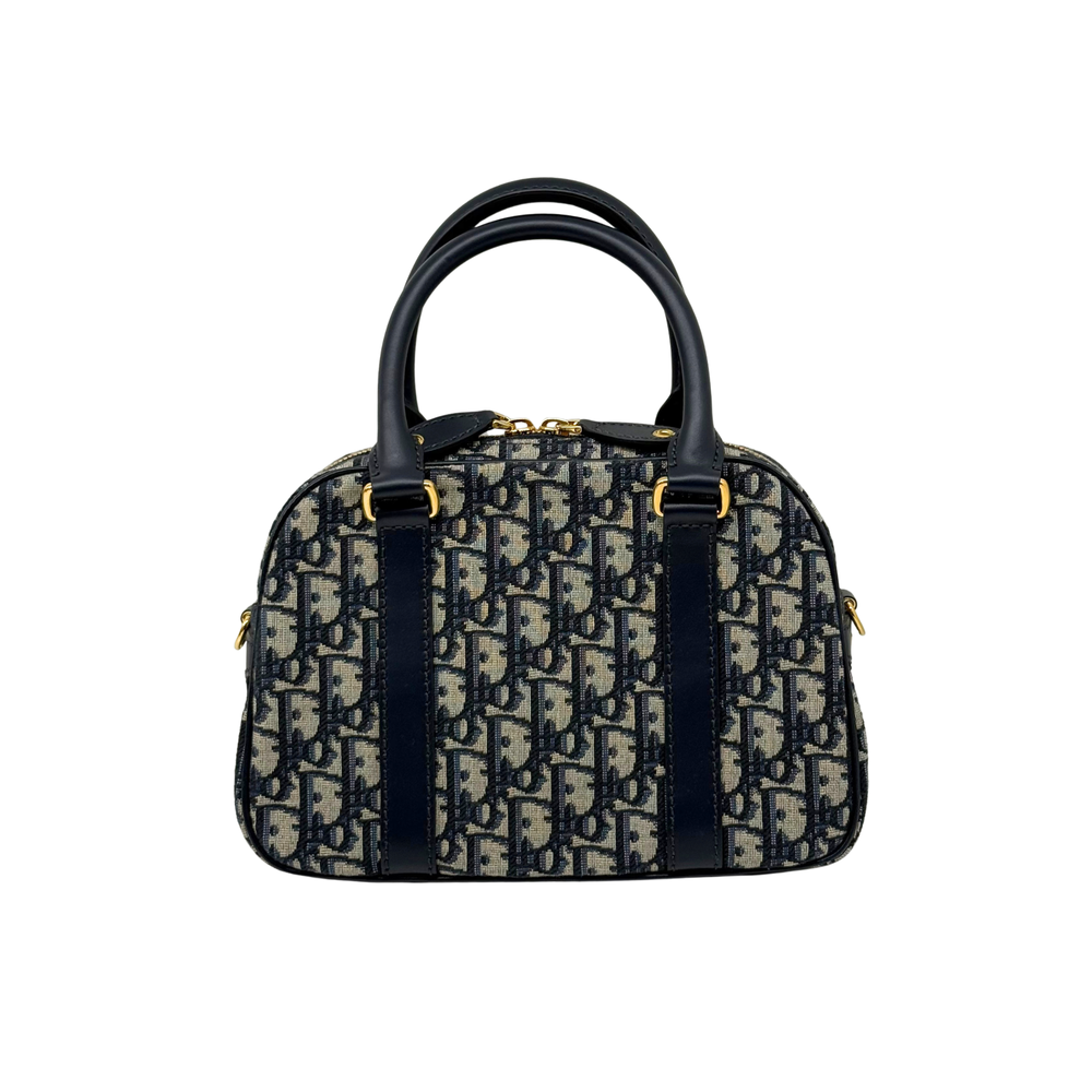 Dior mini duffel bag with navy handles, blue/cream monogram canvas, gold zipper