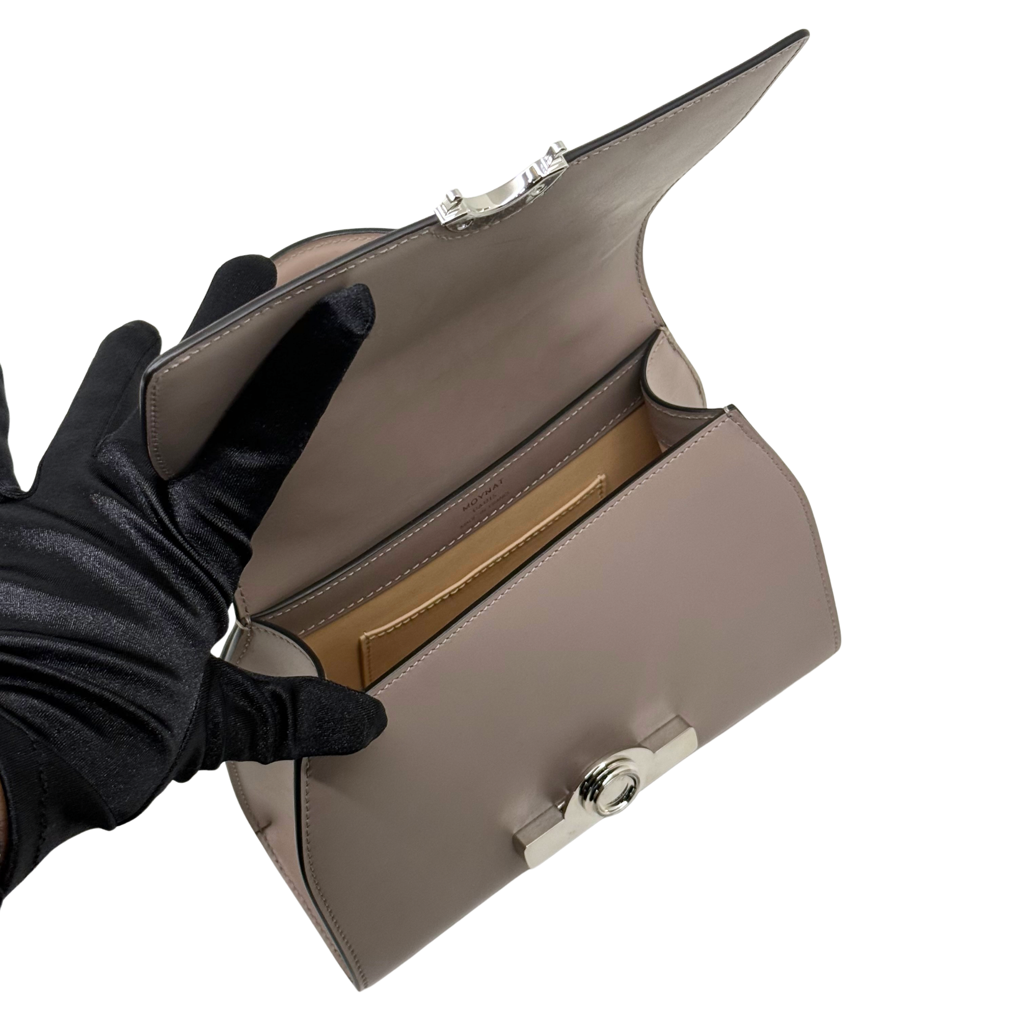 Moynat taupe leather handbag open view, showing interior and front clasp detail