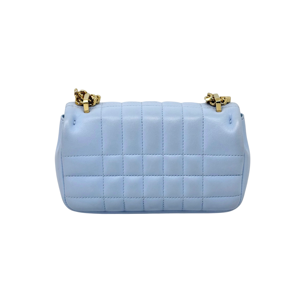 Light blue quilted mini bag with gold chain handles and front B emblem.