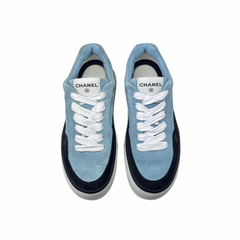 Blue suede sneakers with CHANEL logo tongue and white lace-up front