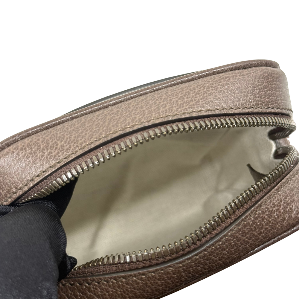 Gucci GG canvas toiletry bag interior with zippered opening and brown leather trim
