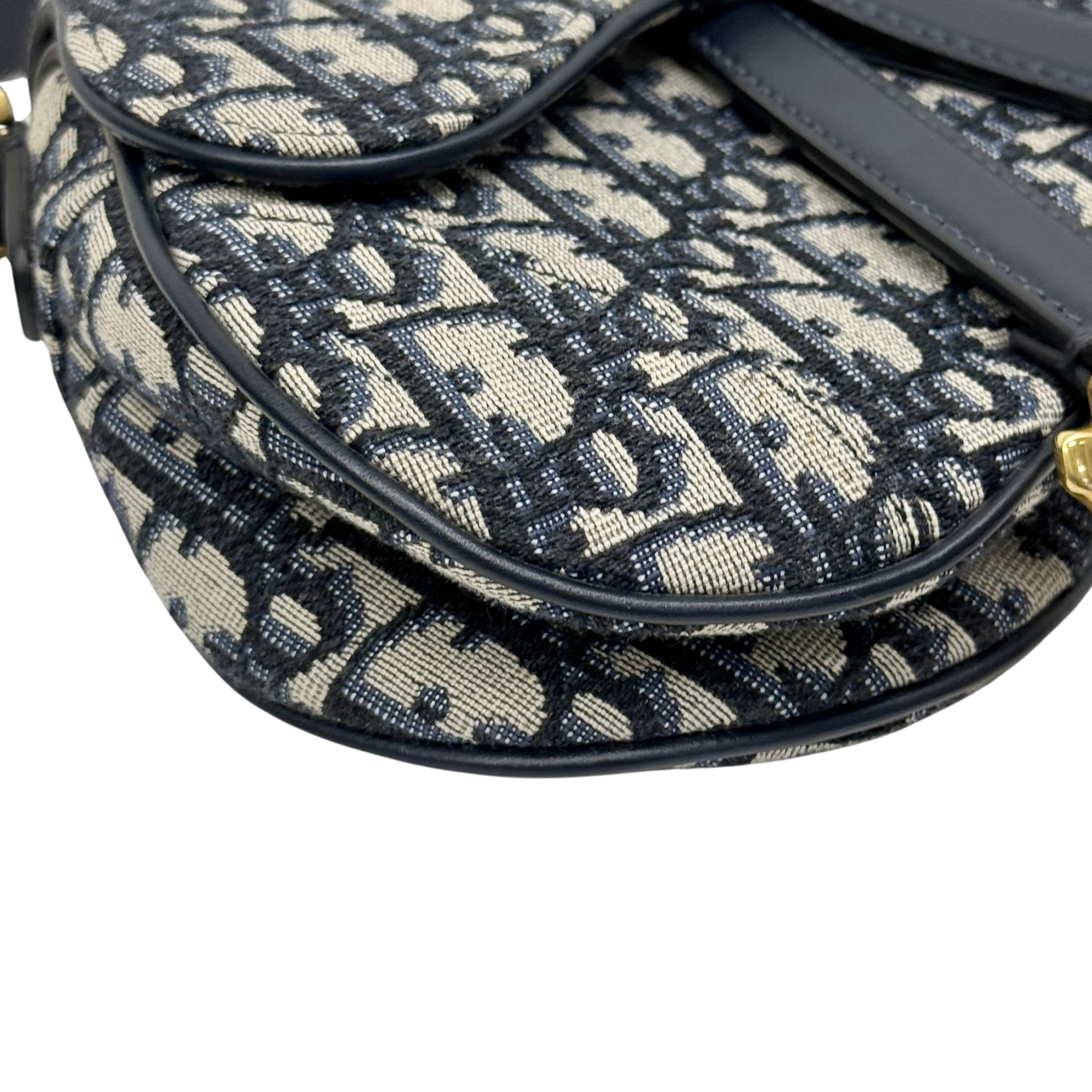 Curved logo-print mini bag with black piping and textured fabric surface