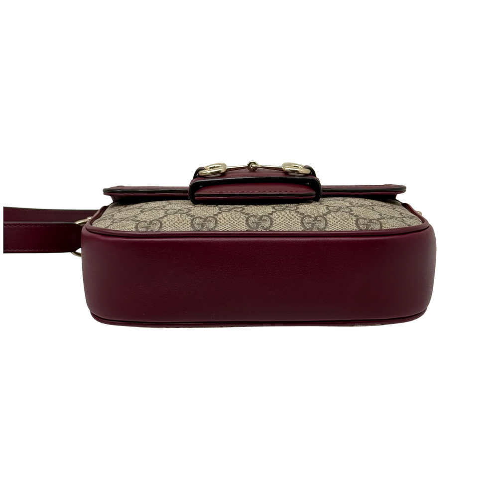 Gucci crossbody bag profile with burgundy leather bottom and gold buckle hardware