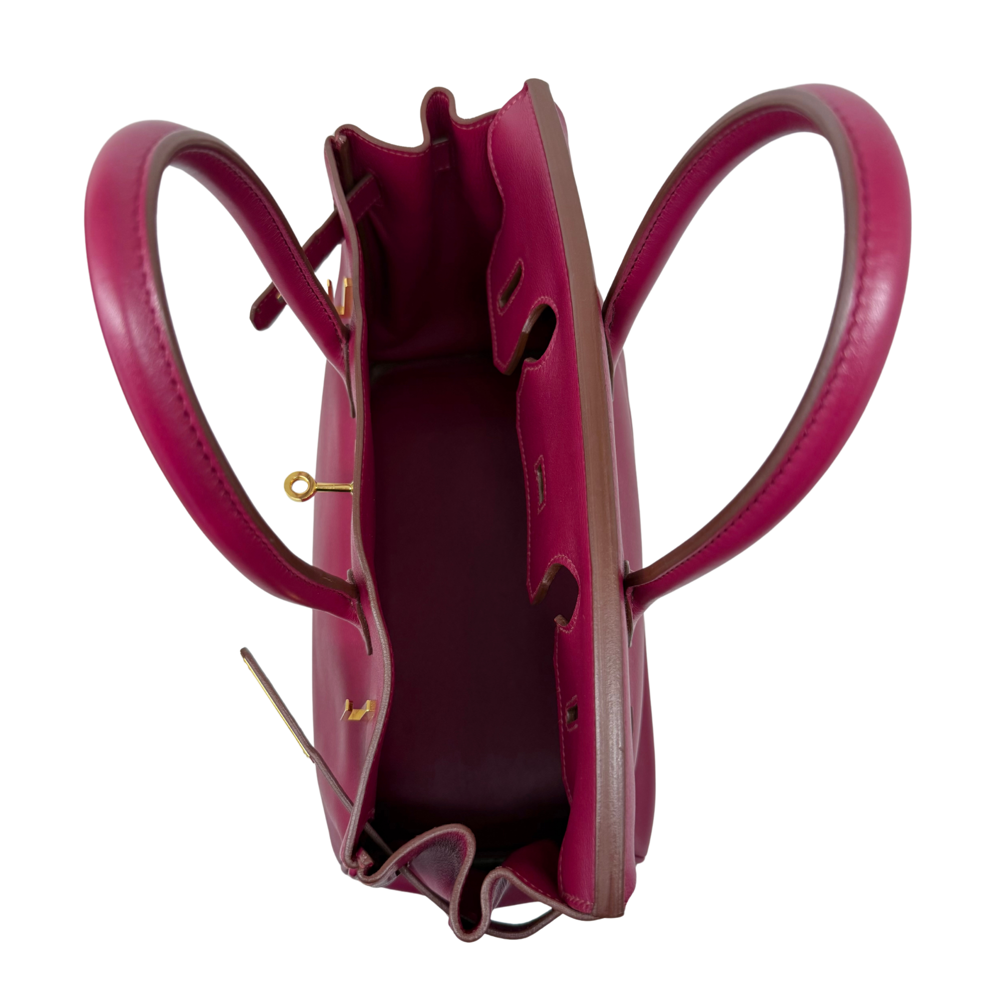 Magenta leather Birkin bag open interior with pocket and top handle loops
