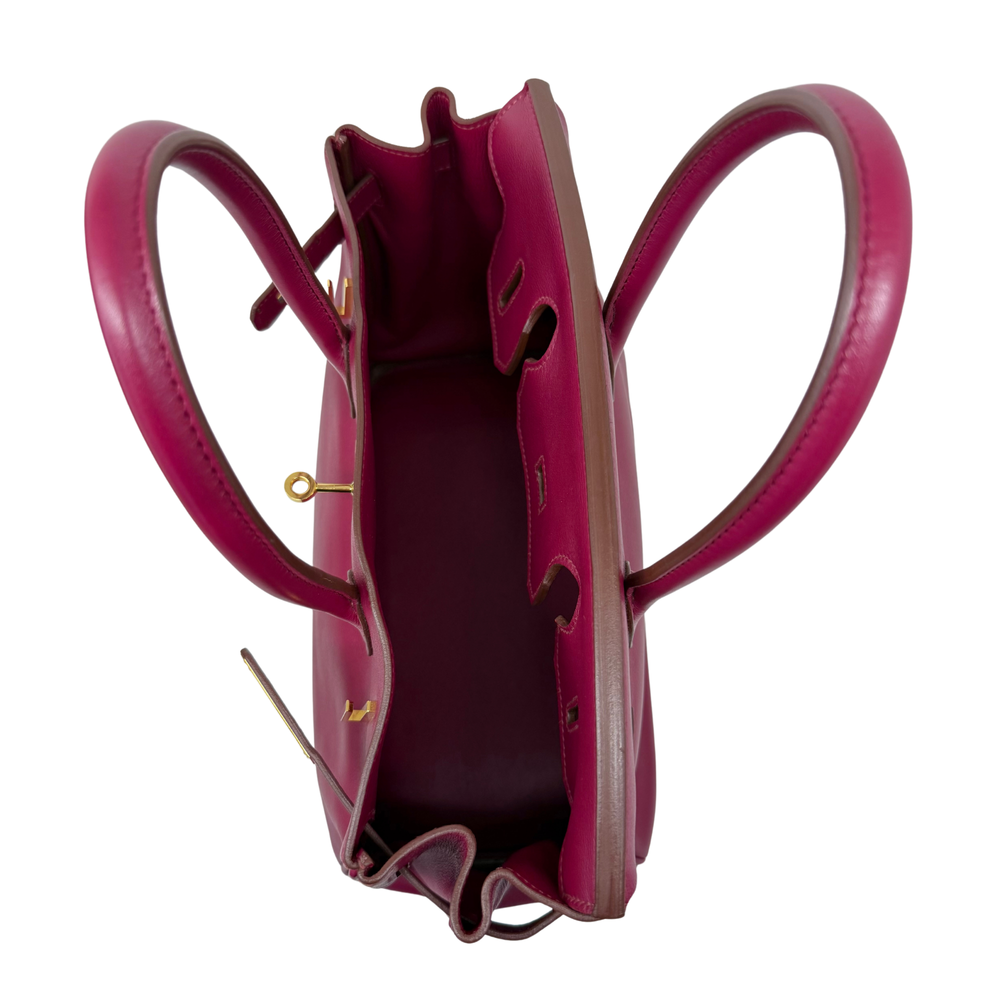 Magenta leather Birkin bag open interior with pocket and top handle loops