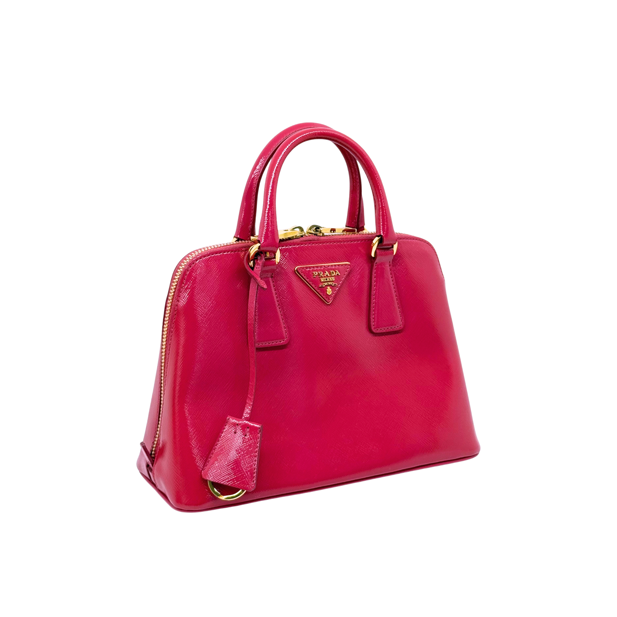 Pink Prada handbag with top handles, gold-tone hardware, hanging leather tag