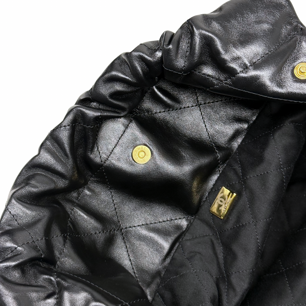 Black quilted leather interior flap with gold snap and stitched panels
