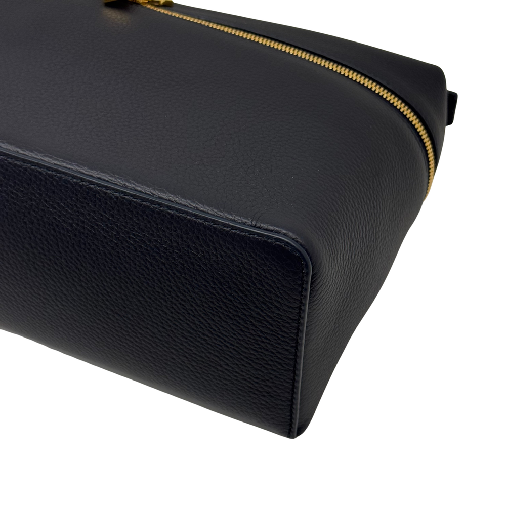 Black leather pouch corner with gold-trim zipper edge
