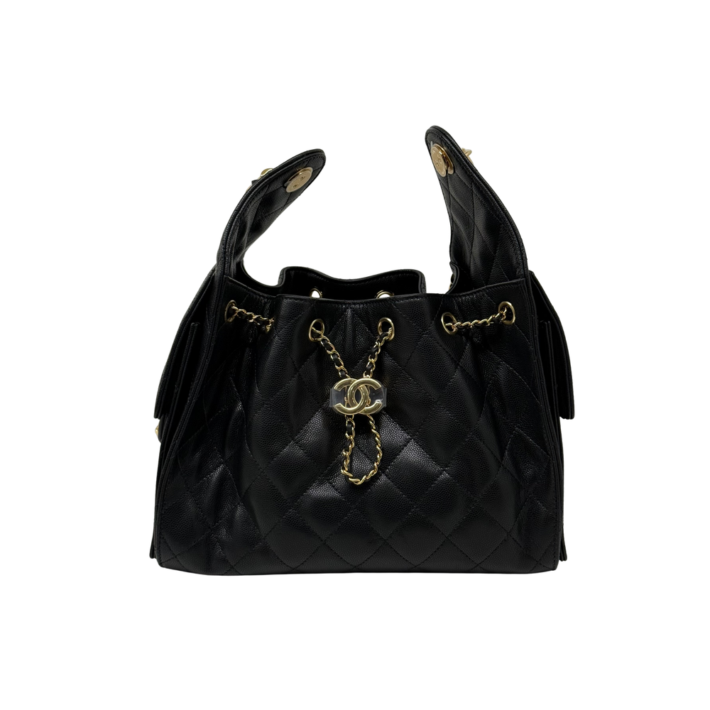 Black quilted handbag with top handles, gold chain, and dangling charm
