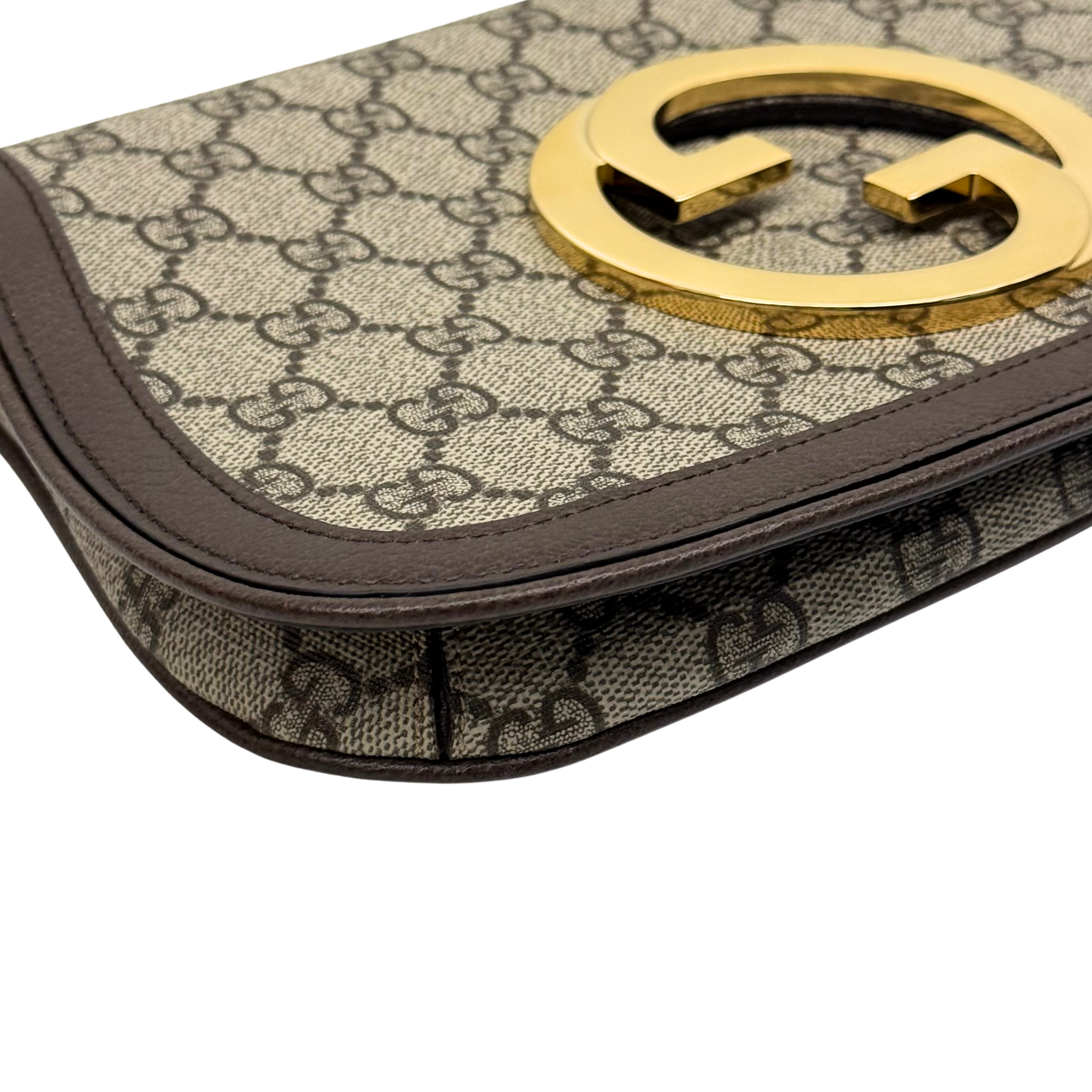 Gucci GG canvas crossbody bag with gold-tone G logo on brown leather trim