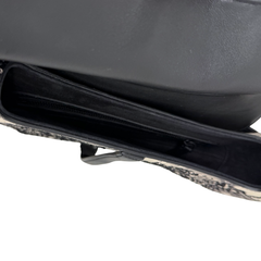 Christian Dior saddle bag side opening with black zip and dark leather trim.
