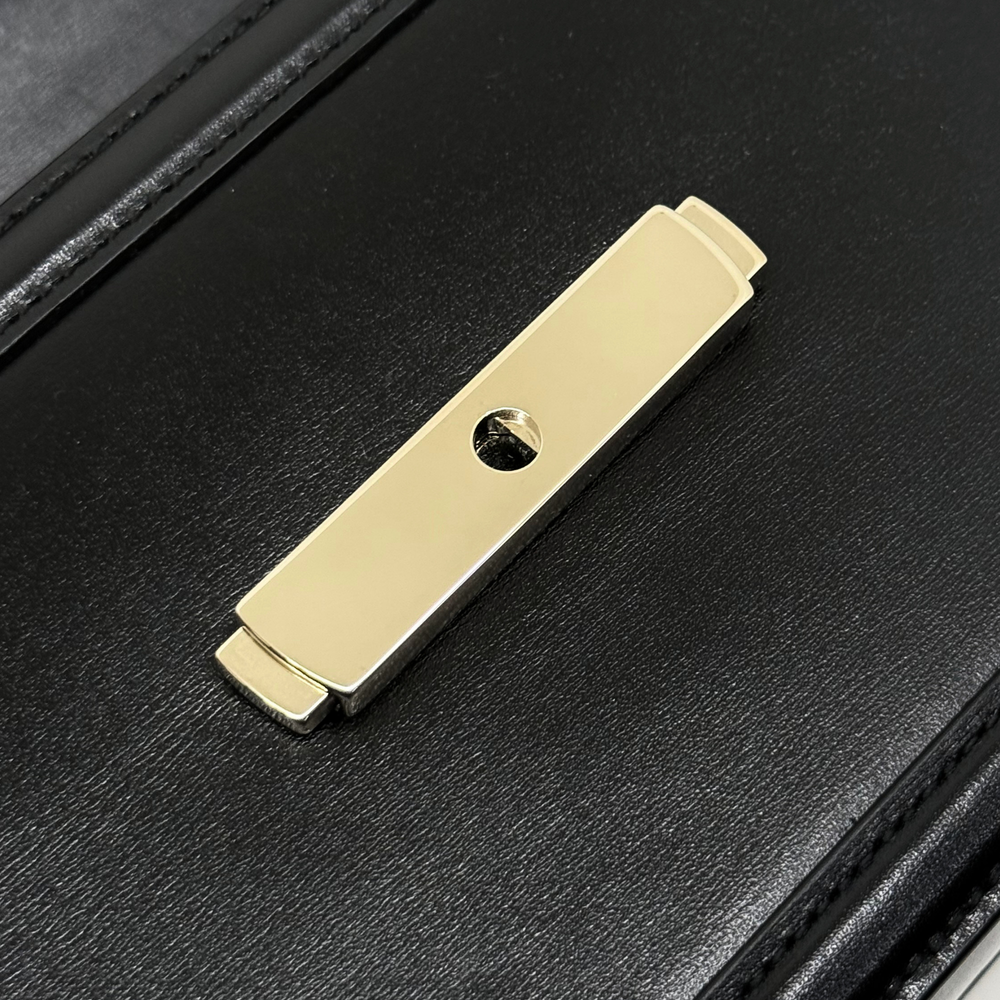 Black leather snap bar with gold-tone button hardware